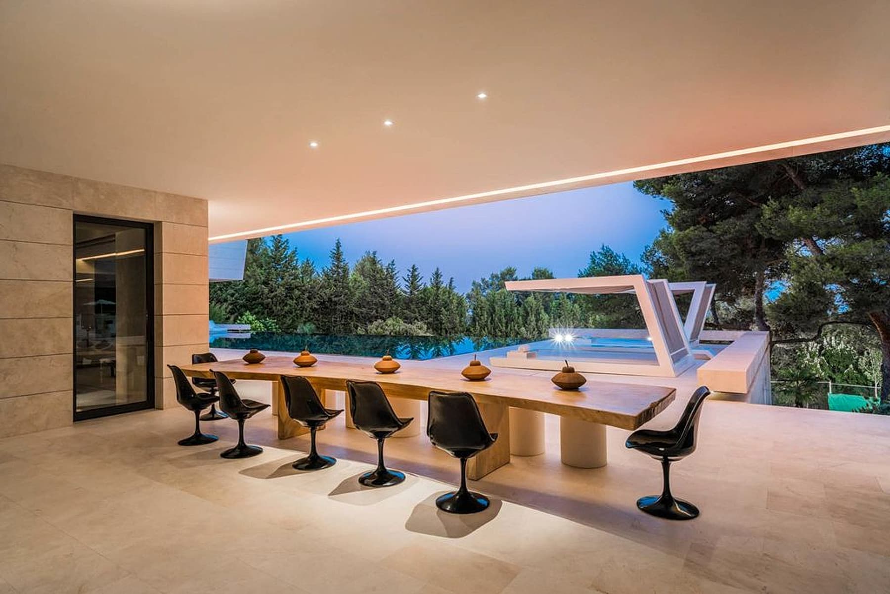 Outdoor dining bar facing the pool and garden